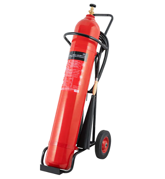 How is the discharge nozzle on a trolley-type CO₂ fire extinguisher designed to direct the flow of CO₂ effectively?